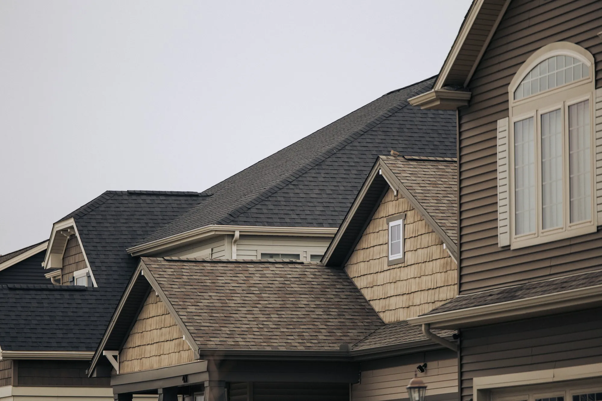 Suburban house with multiple gables and an asphalt shingle roof