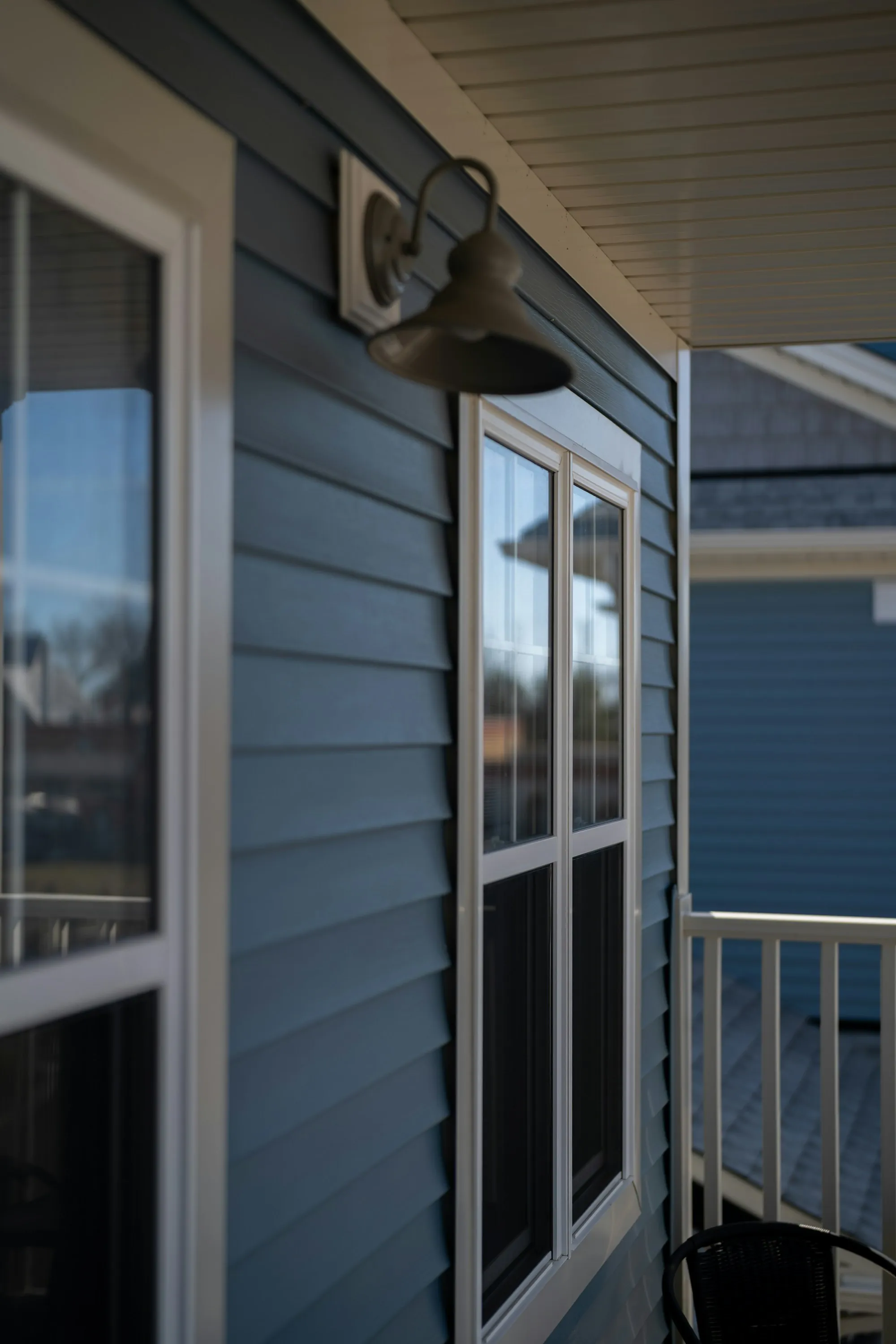 Lap siding and white window trim on a suburban house