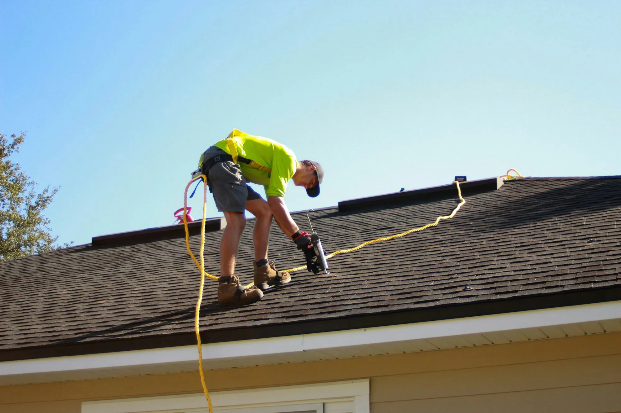 Roofer making a repair at a flashing detail on a residential roof
