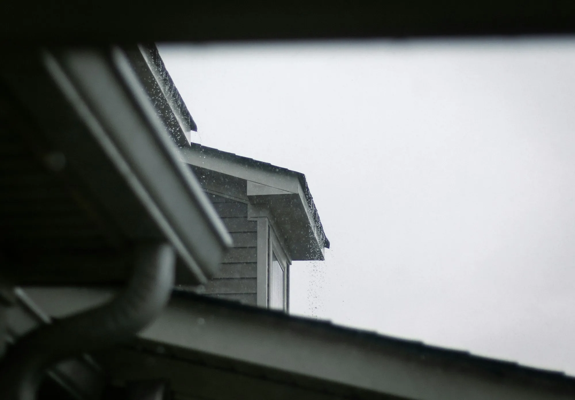 White gutter and fascia running along the eaves of a house